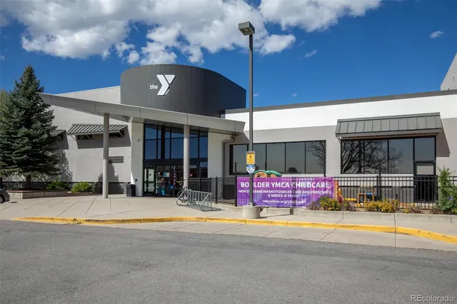 a view of building with large windows and a table
