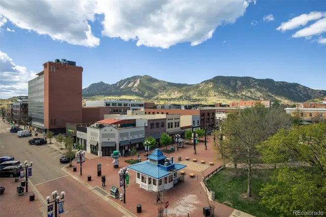 a view of multiple houses with a city view