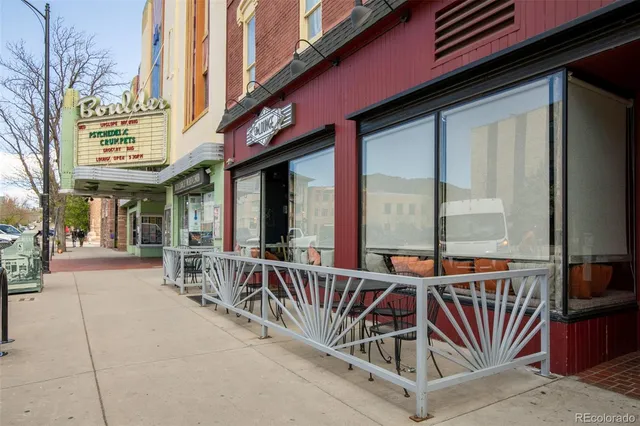 a view of a patio with a table and chairs