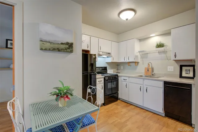 a kitchen with granite countertop a sink stainless steel appliances and cabinets