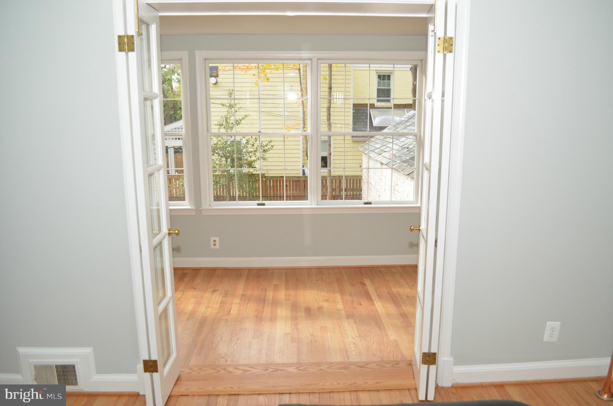 3134 38th Street Northwest Washington, DC 20016 - Photo 12 of 30 a view of an empty room with wooden floor and a window