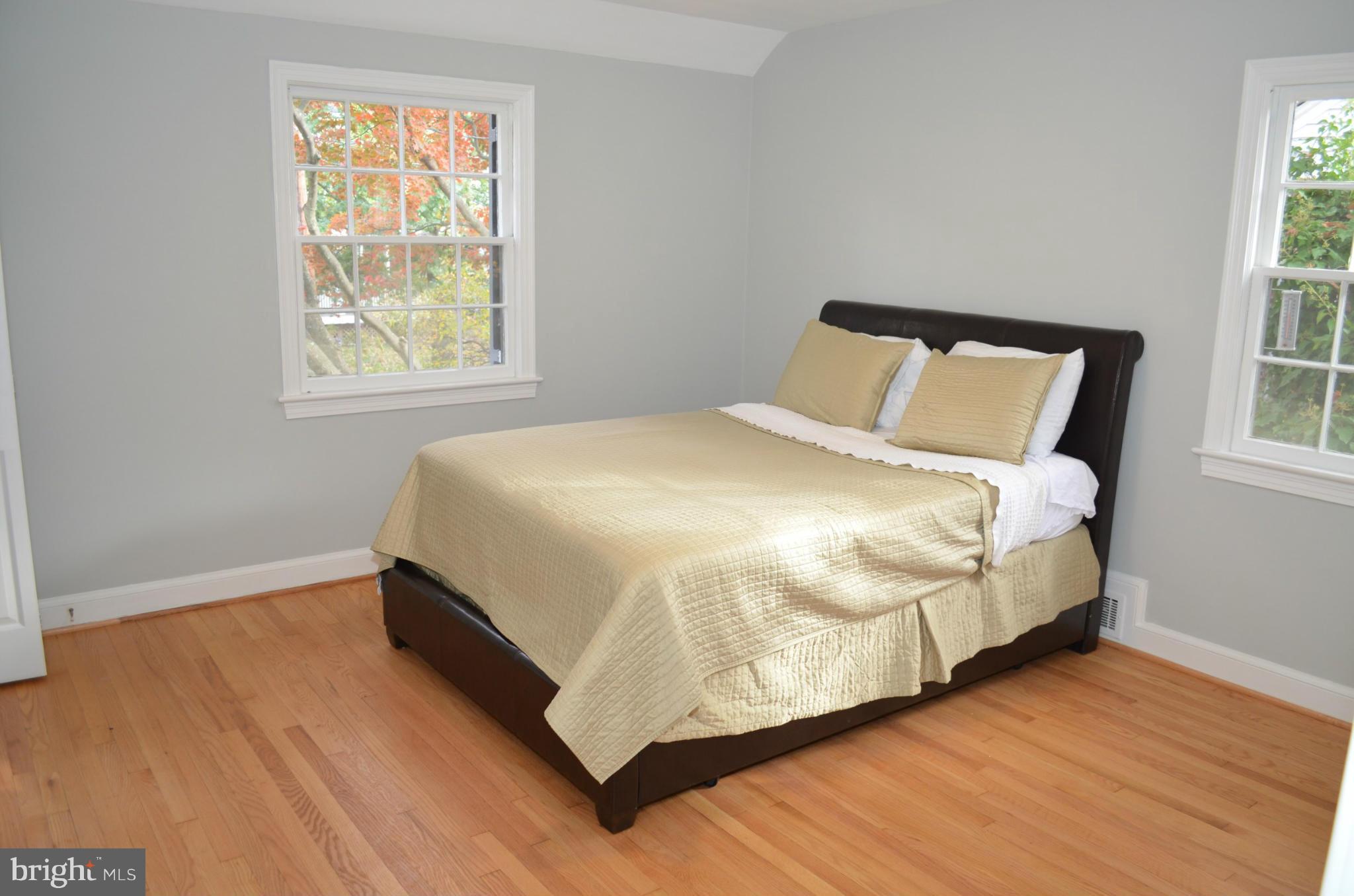 3134 38th Street Northwest Washington, DC 20016 - Photo 16 of 30 a large bed sitting in a bedroom next to a window