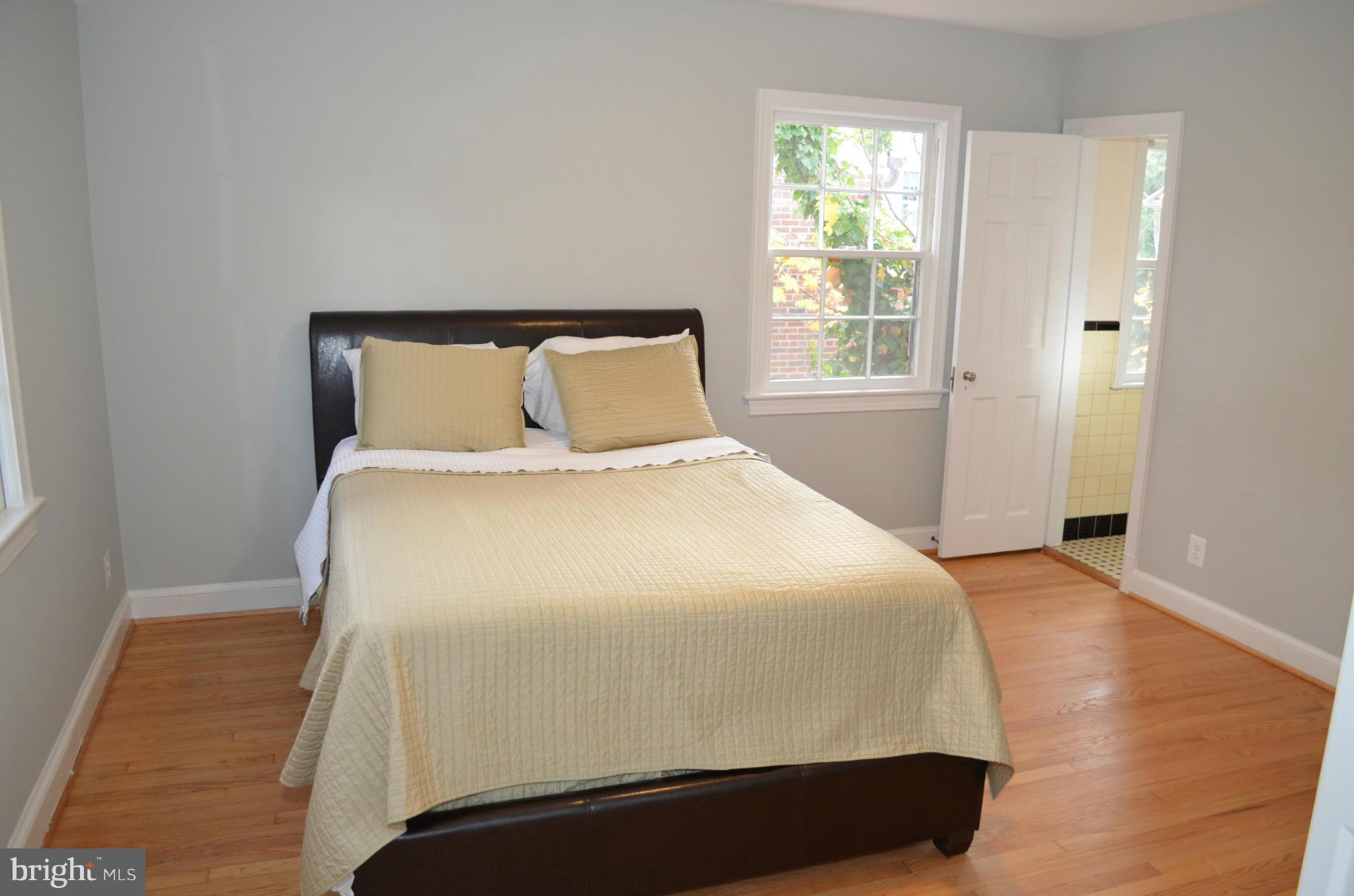 3134 38th Street Northwest Washington, DC 20016 - Photo 17 of 30 a large bed sitting in a bedroom next to a window