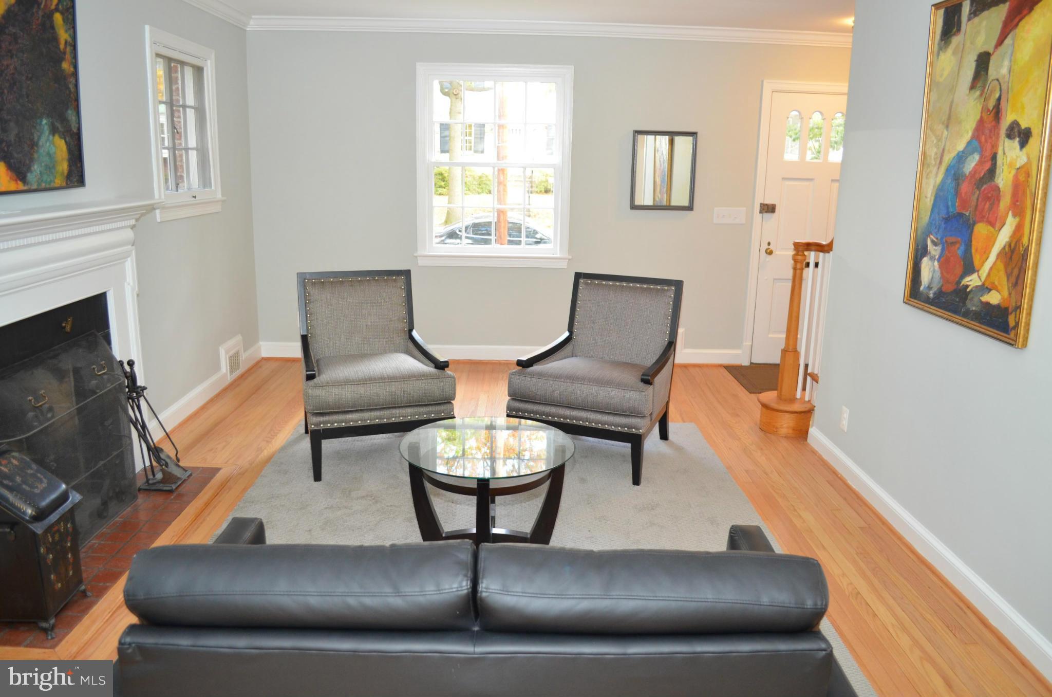 3134 38th Street Northwest Washington, DC 20016 - Photo 4 of 30 a living room with couches chair and a fireplace with wooden floor