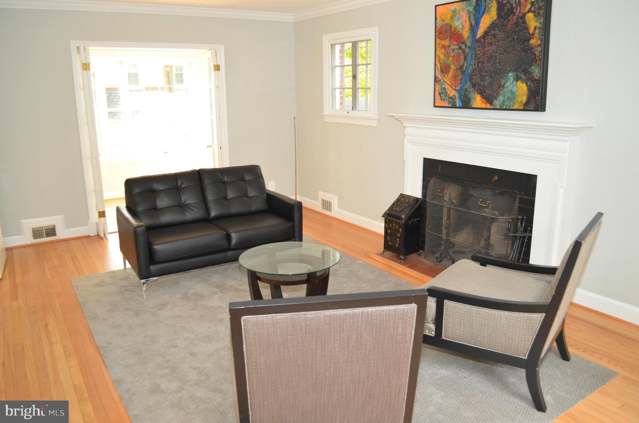 3134 38th Street Northwest Washington, DC 20016 - Photo 6 of 30 a living room with furniture and a fireplace