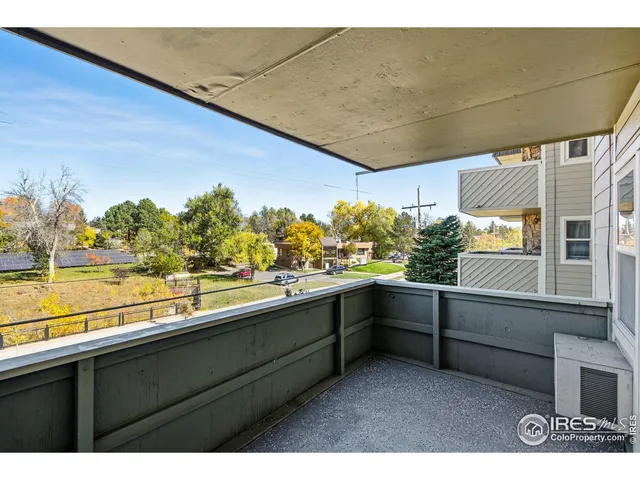 a kitchen with cabinets and wooden floor