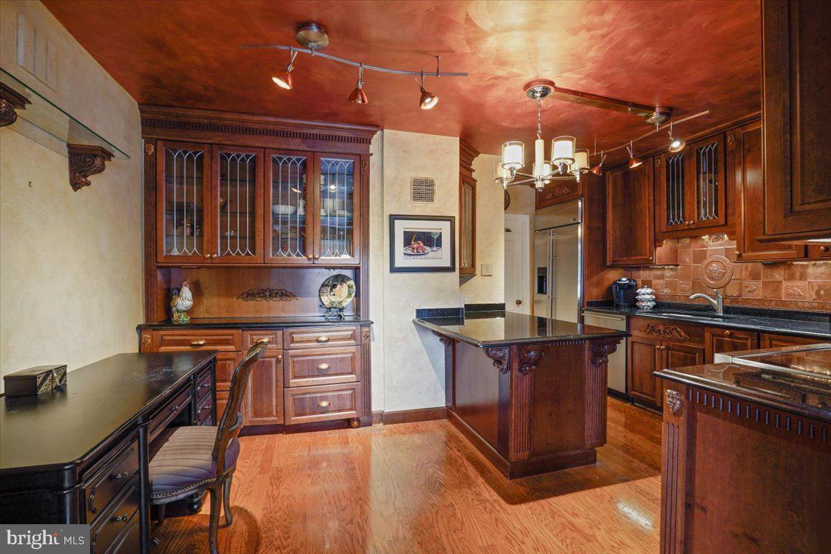 800 25th Street Northwest, Unit 504 Washington, DC 20037 - Photo 16 of 52 Elegant kitchen with rich wood tones.