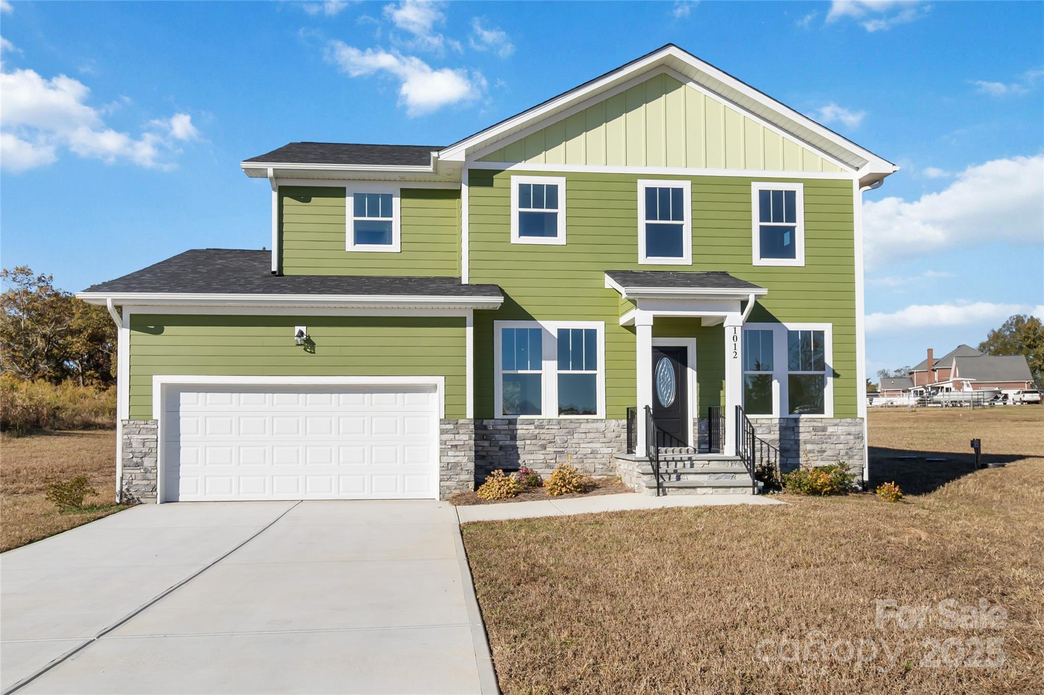 a front view of a house with a yard and garage