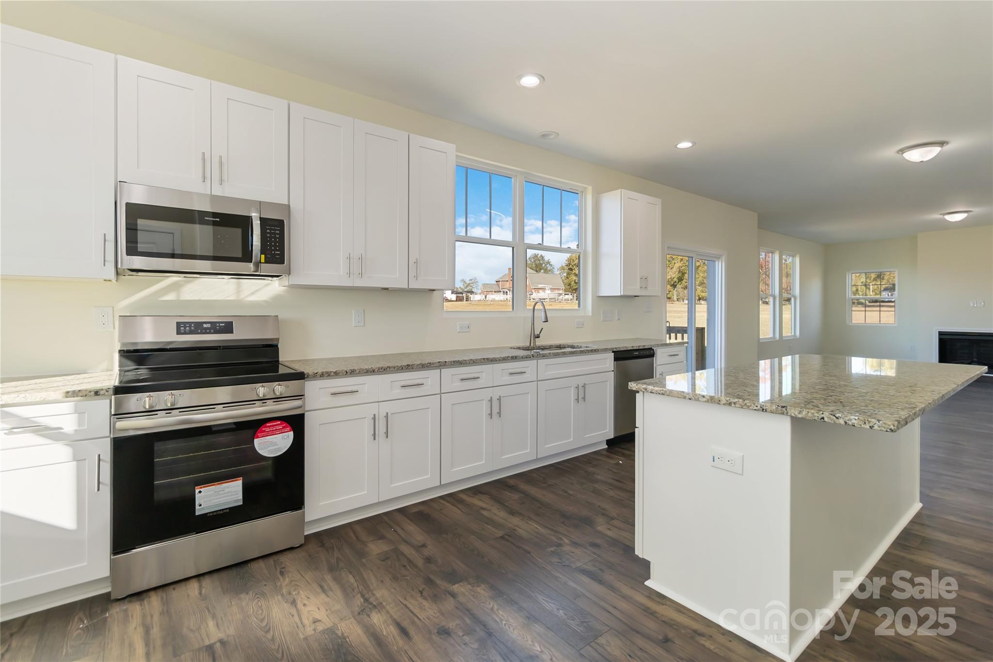 1012 Heath Helms Road Monroe, NC 28110 - Photo 18 of 48 a kitchen with stainless steel appliances granite countertop a stove a sink and a microwave
