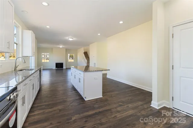 a view of a kitchen with wooden floor and a sink