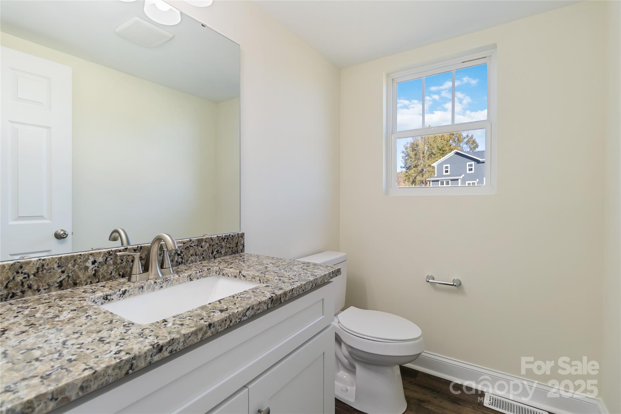 1012 Heath Helms Road Monroe, NC 28110 - Photo 20 of 48 a bathroom with a granite countertop sink a toilet and a mirror