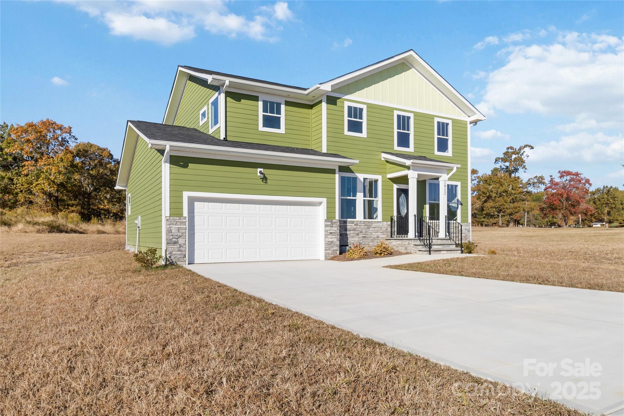 1012 Heath Helms Road Monroe, NC 28110 - Photo 2 of 48 a front view of a house with a yard and garage