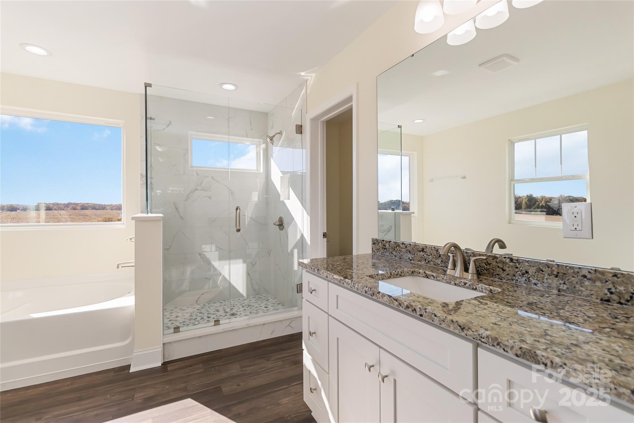 1012 Heath Helms Road Monroe, NC 28110 - Photo 35 of 48 a bathroom with a granite countertop sink a shower and a mirror