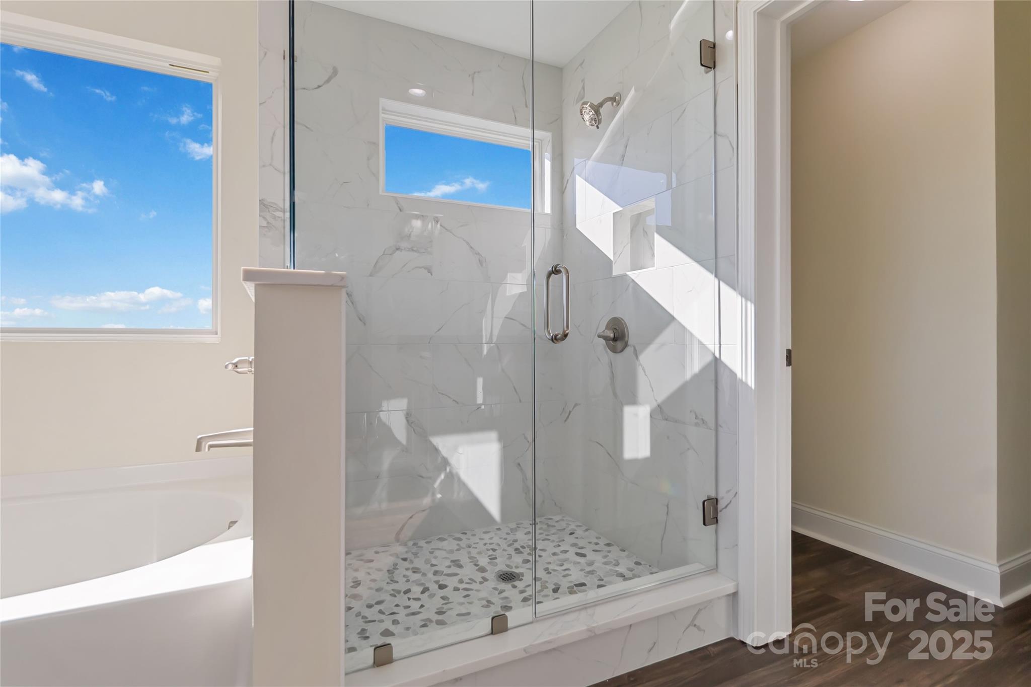 1012 Heath Helms Road Monroe, NC 28110 - Photo 38 of 48 a bathroom with a glass shower door and a glass door
