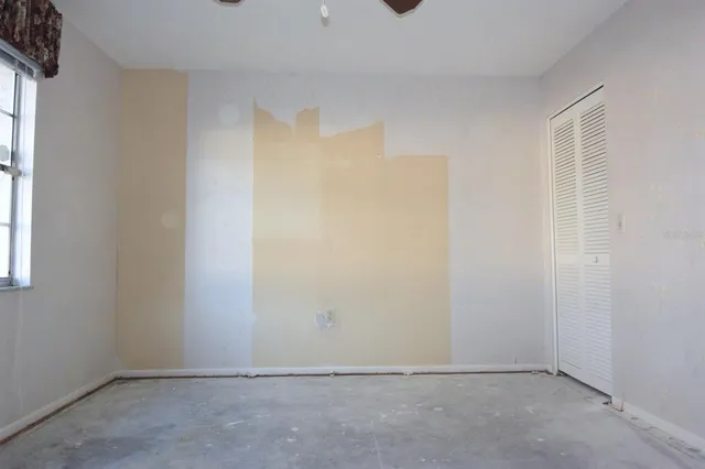 an empty room with a empty space and windows