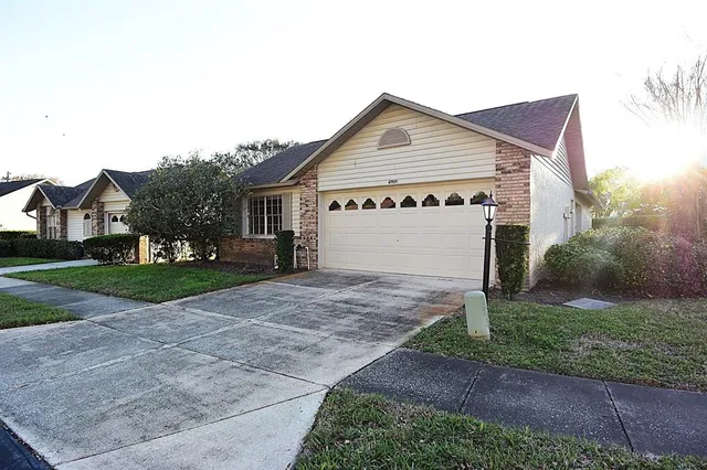 a view of a house with a yard and garage
