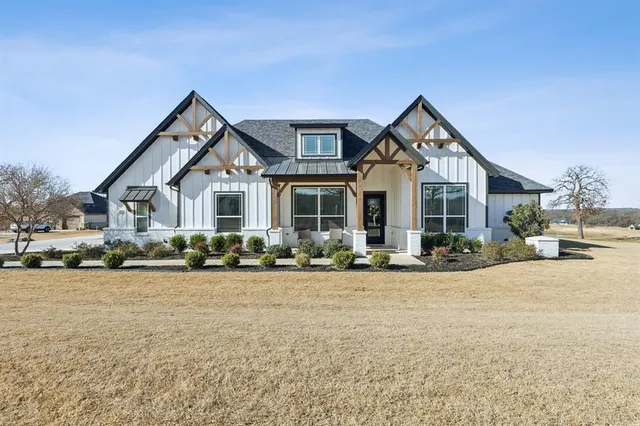 a front view of a house with yard and porch