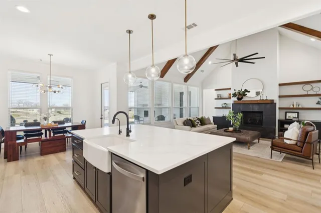 a kitchen with sink stove and cabinets