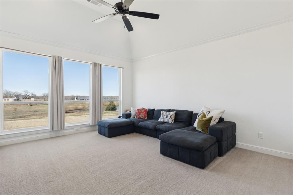 125 San Miguel Drive Decatur, TX 76234 - Photo 16 of 36 a living room with furniture and a floor to ceiling window