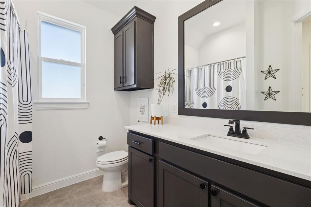 125 San Miguel Drive Decatur, TX 76234 - Photo 19 of 36 a bathroom with a toilet sink and mirror