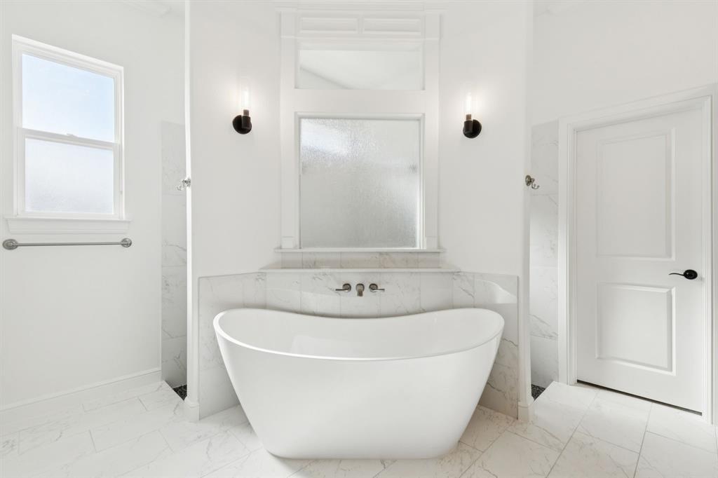 125 San Miguel Drive Decatur, TX 76234 - Photo 23 of 36 a white bath tub sitting in a bathroom