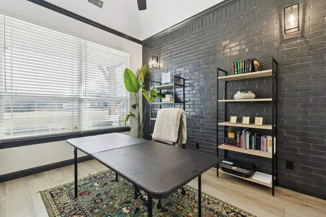a view of a workspace with furniture and a window
