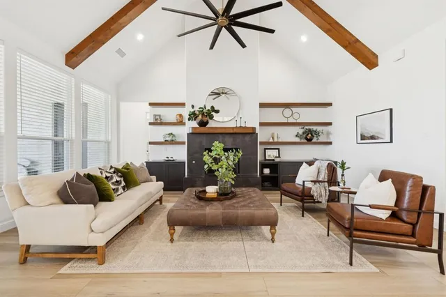 a living room with furniture a fireplace and a flat screen tv