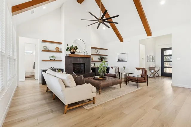 a living room with furniture and a view of kitchen