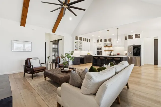 a living room with furniture and kitchen view