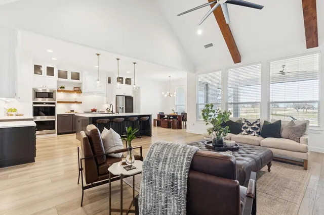a living room with furniture a fireplace and a table