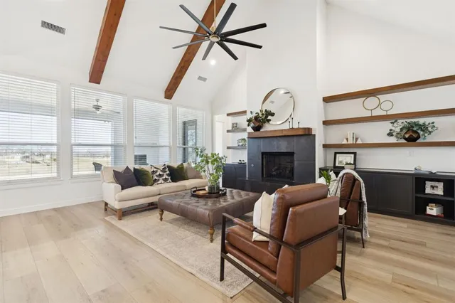 a kitchen with granite countertop a table chairs sink and cabinets