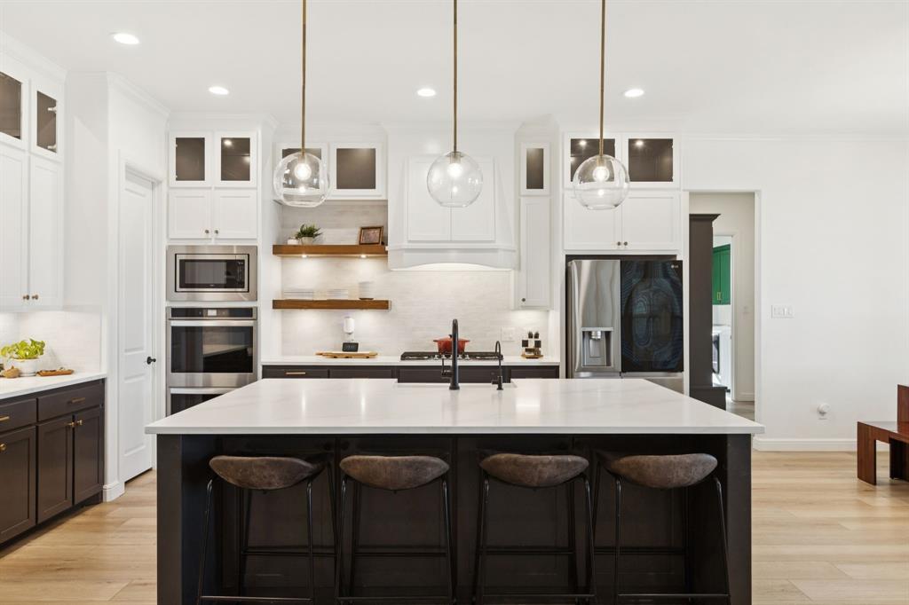 125 San Miguel Drive Decatur, TX 76234 - Photo 10 of 36 a kitchen with granite countertop a table chairs sink and cabinets