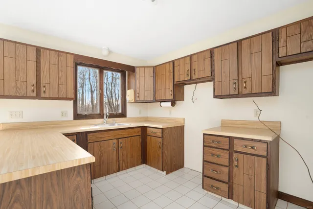 a kitchen with a sink stove and cabinets