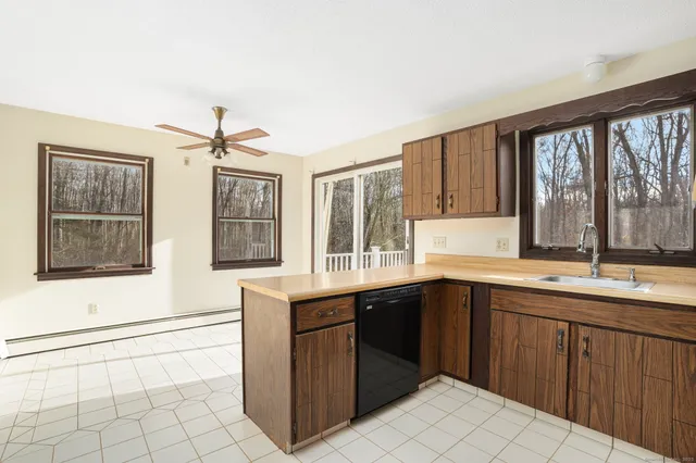a kitchen with a sink and large window