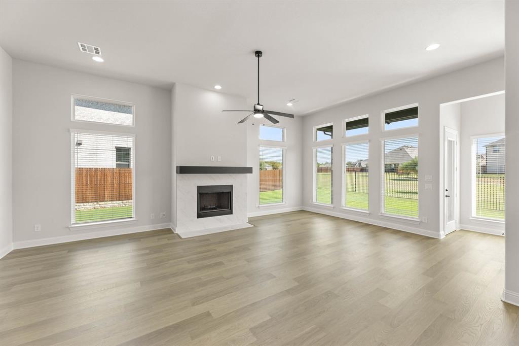 5210 Rowlan Row Midlothian, TX 76065 - Photo 11 of 40 a view of an empty room with glass door and wooden floor
