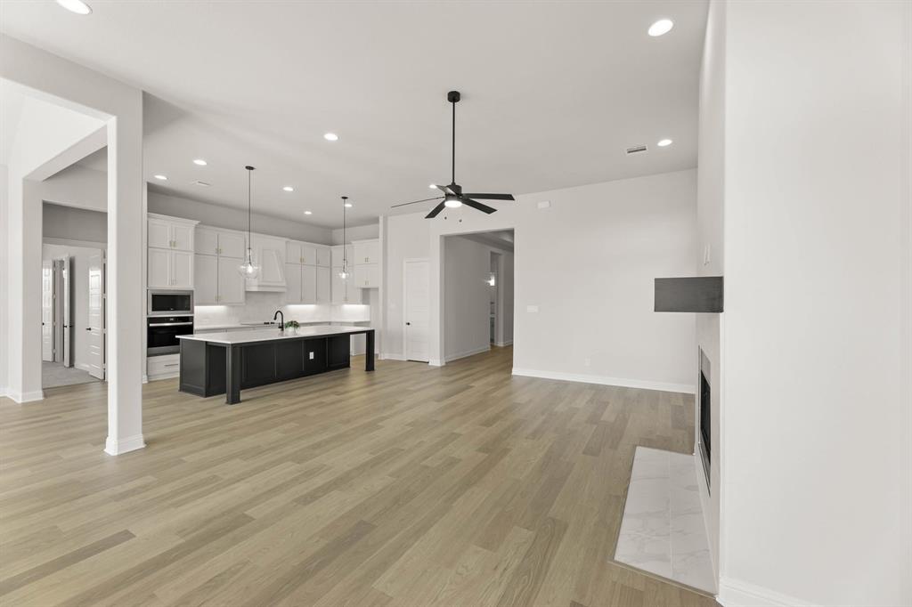 5210 Rowlan Row Midlothian, TX 76065 - Photo 13 of 40 a large kitchen with a lot of cabinets and wooden floor