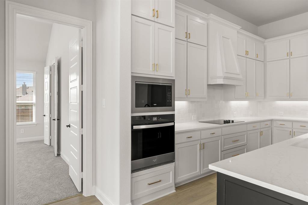 5210 Rowlan Row Midlothian, TX 76065 - Photo 20 of 40 a kitchen with white cabinets and white appliances