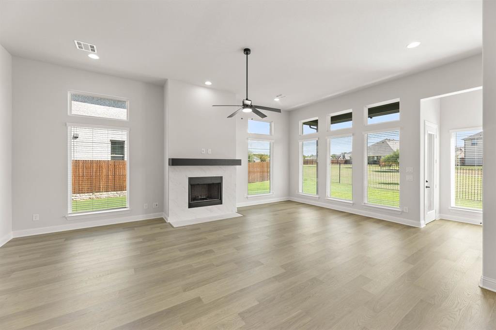 5210 Rowlan Row Midlothian, TX 76065 - Photo 22 of 40 a view of an empty room with a window and wooden floor