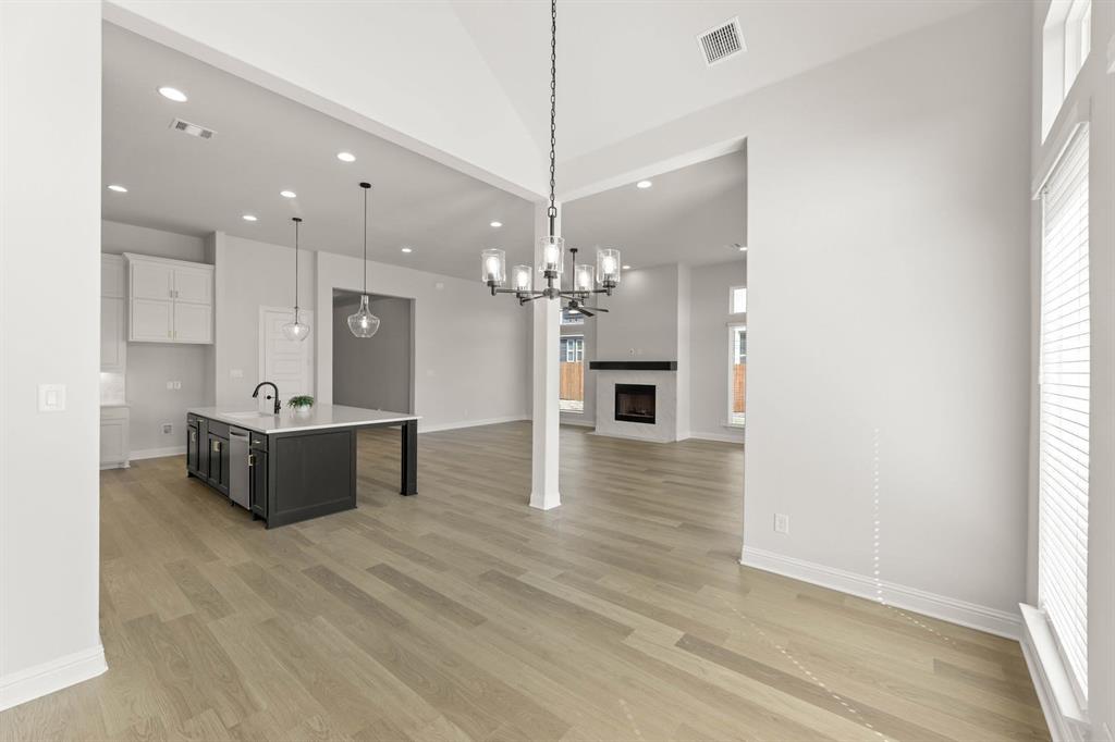 5210 Rowlan Row Midlothian, TX 76065 - Photo 23 of 40 a large white kitchen with a chandelier