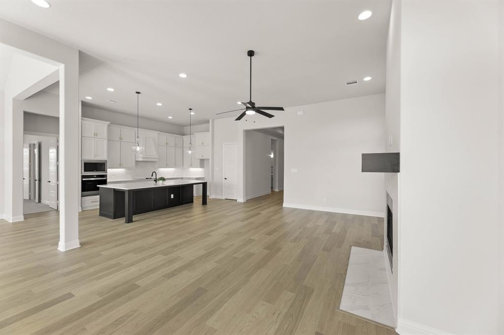 5210 Rowlan Row Midlothian, TX 76065 - Photo 25 of 40 a large kitchen with a lot of cabinets and wooden floor