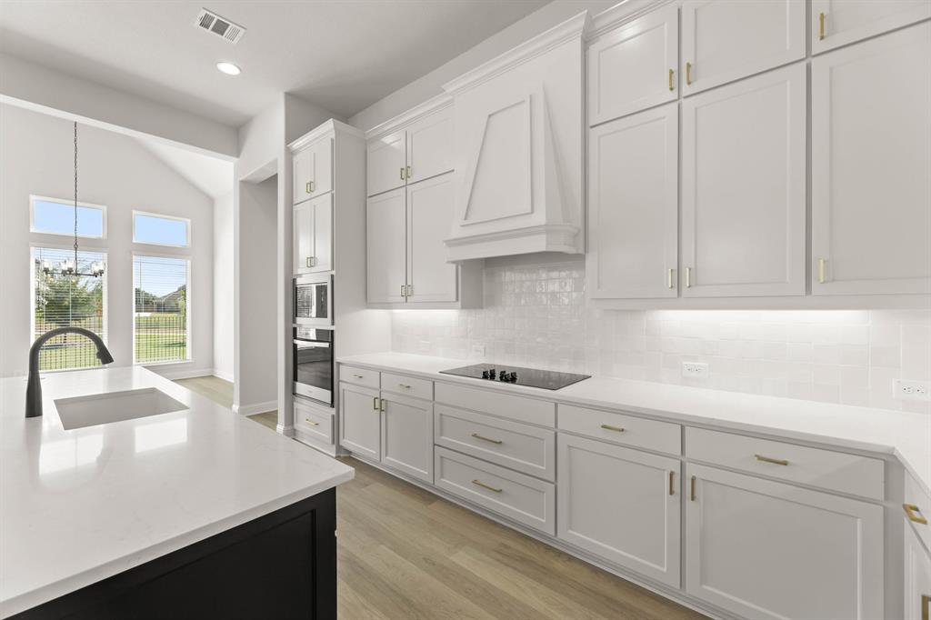 5210 Rowlan Row Midlothian, TX 76065 - Photo 30 of 40 a kitchen with white cabinets and sink