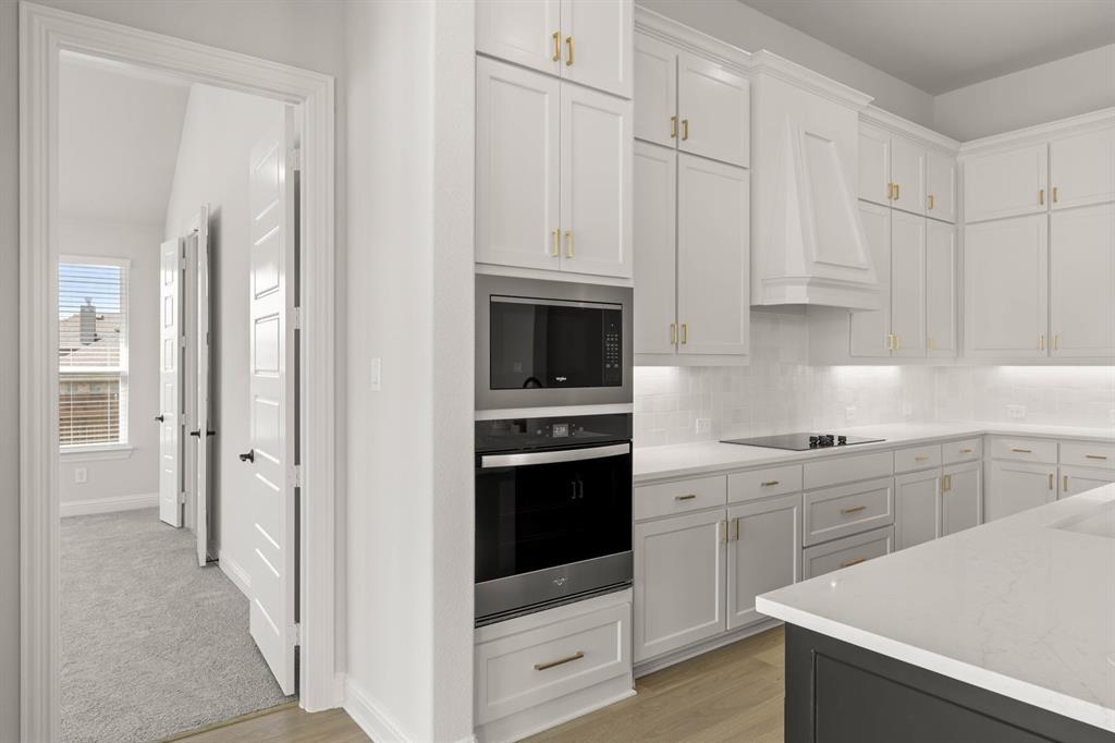 5210 Rowlan Row Midlothian, TX 76065 - Photo 31 of 40 a kitchen with white cabinets and white appliances