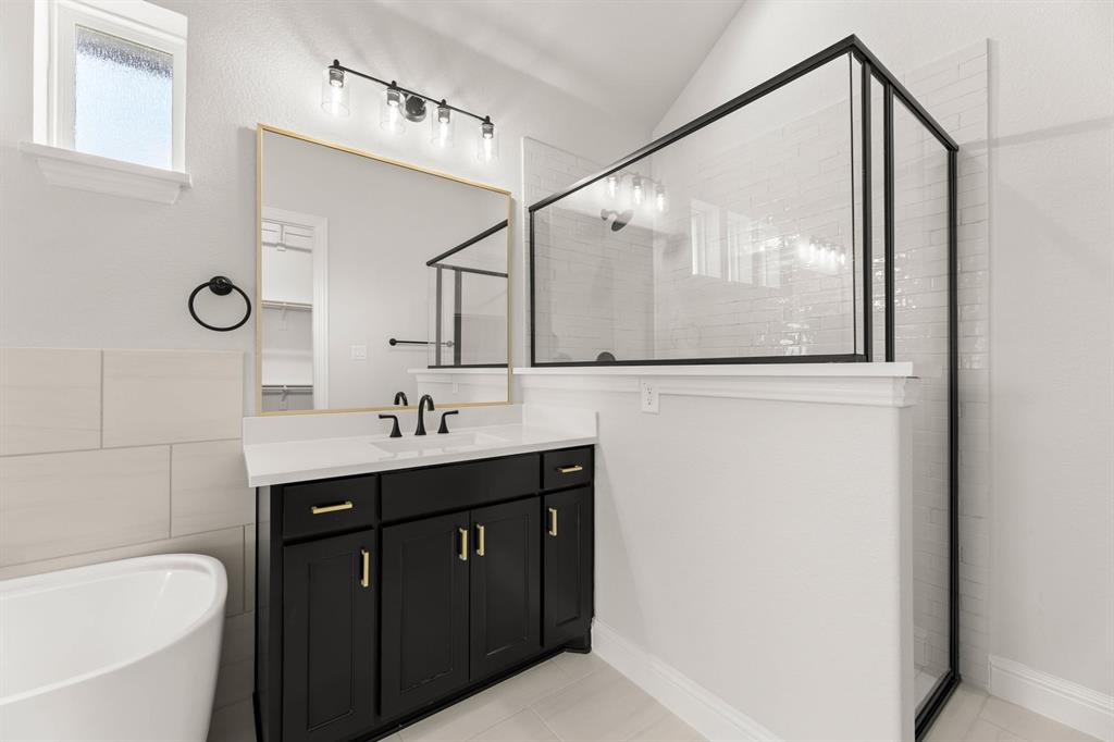 5210 Rowlan Row Midlothian, TX 76065 - Photo 35 of 40 a bathroom with a bathtub sink and mirror