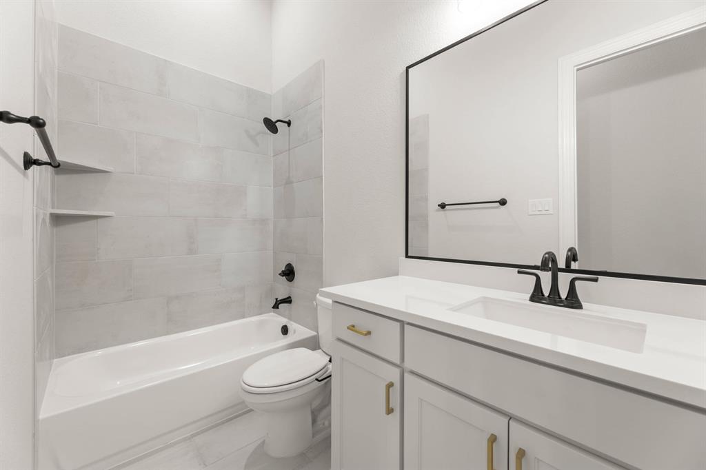 5210 Rowlan Row Midlothian, TX 76065 - Photo 38 of 40 a bathroom with a sink a toilet and shower