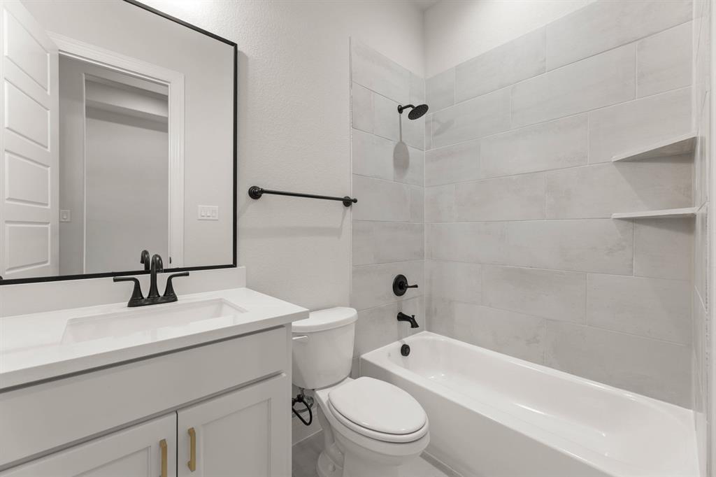 5210 Rowlan Row Midlothian, TX 76065 - Photo 39 of 40 a bathroom with a sink a toilet and shower