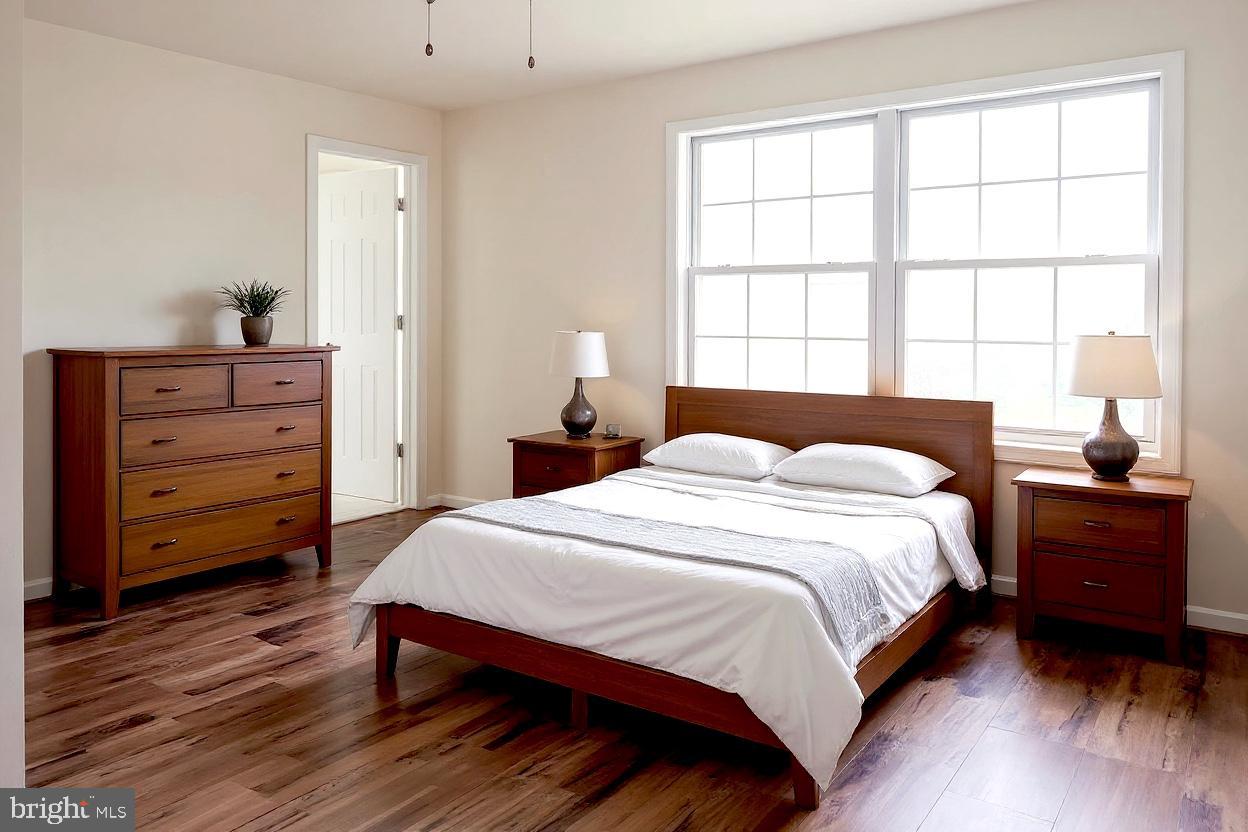 8461 Tackhouse Loop Gainesville, VA 20155 - Photo 11 of 39 a bedroom with a bed and a window