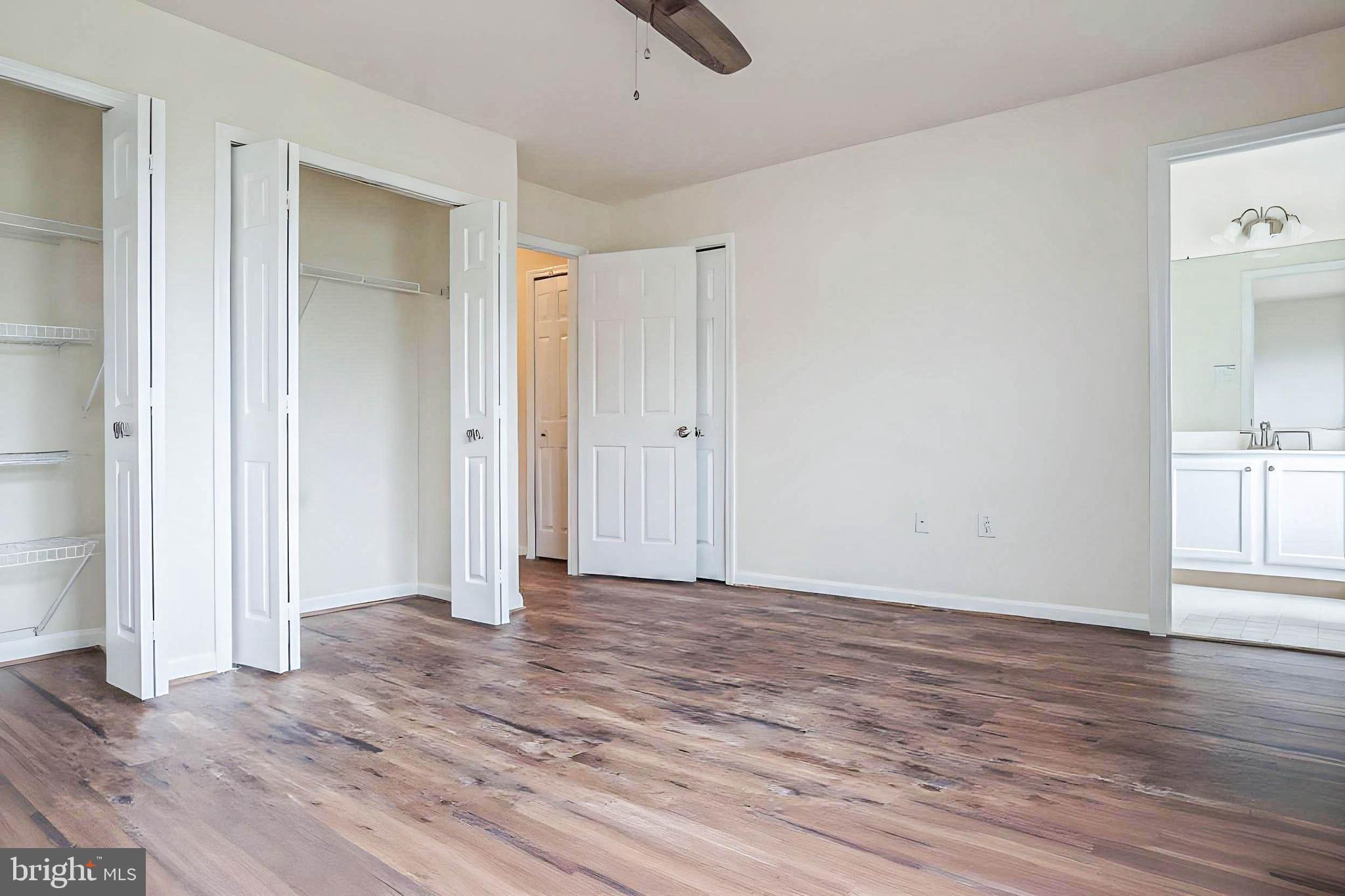 8461 Tackhouse Loop Gainesville, VA 20155 - Photo 13 of 39 a view of an empty room with wooden floor and a window