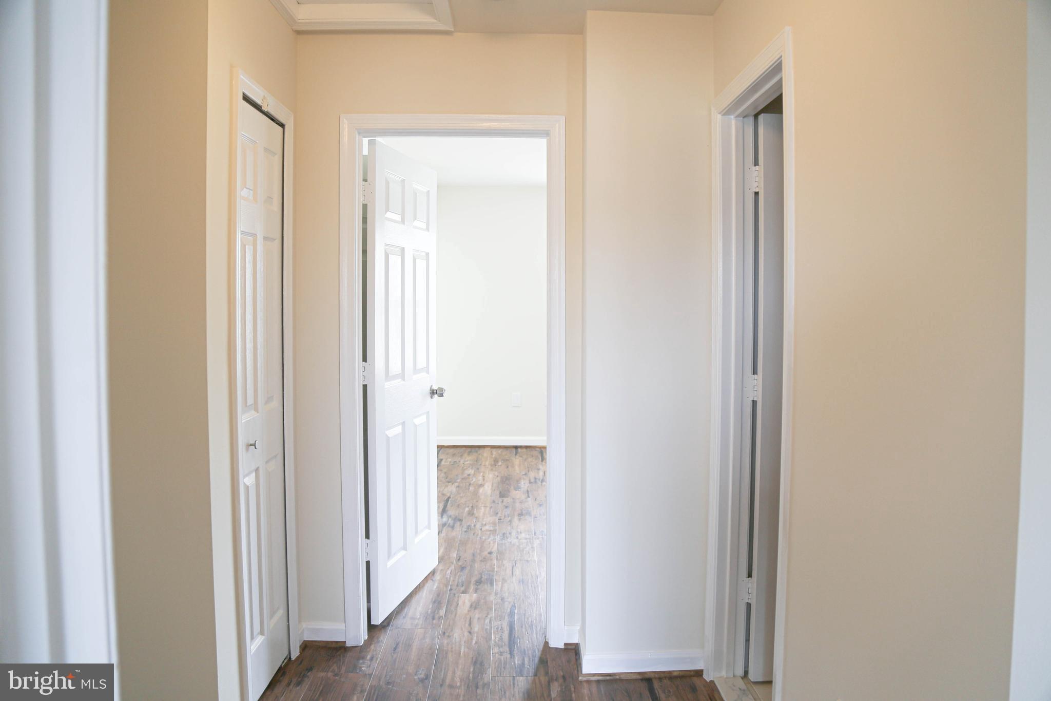 8461 Tackhouse Loop Gainesville, VA 20155 - Photo 14 of 39 a view of a hallway with wooden floor