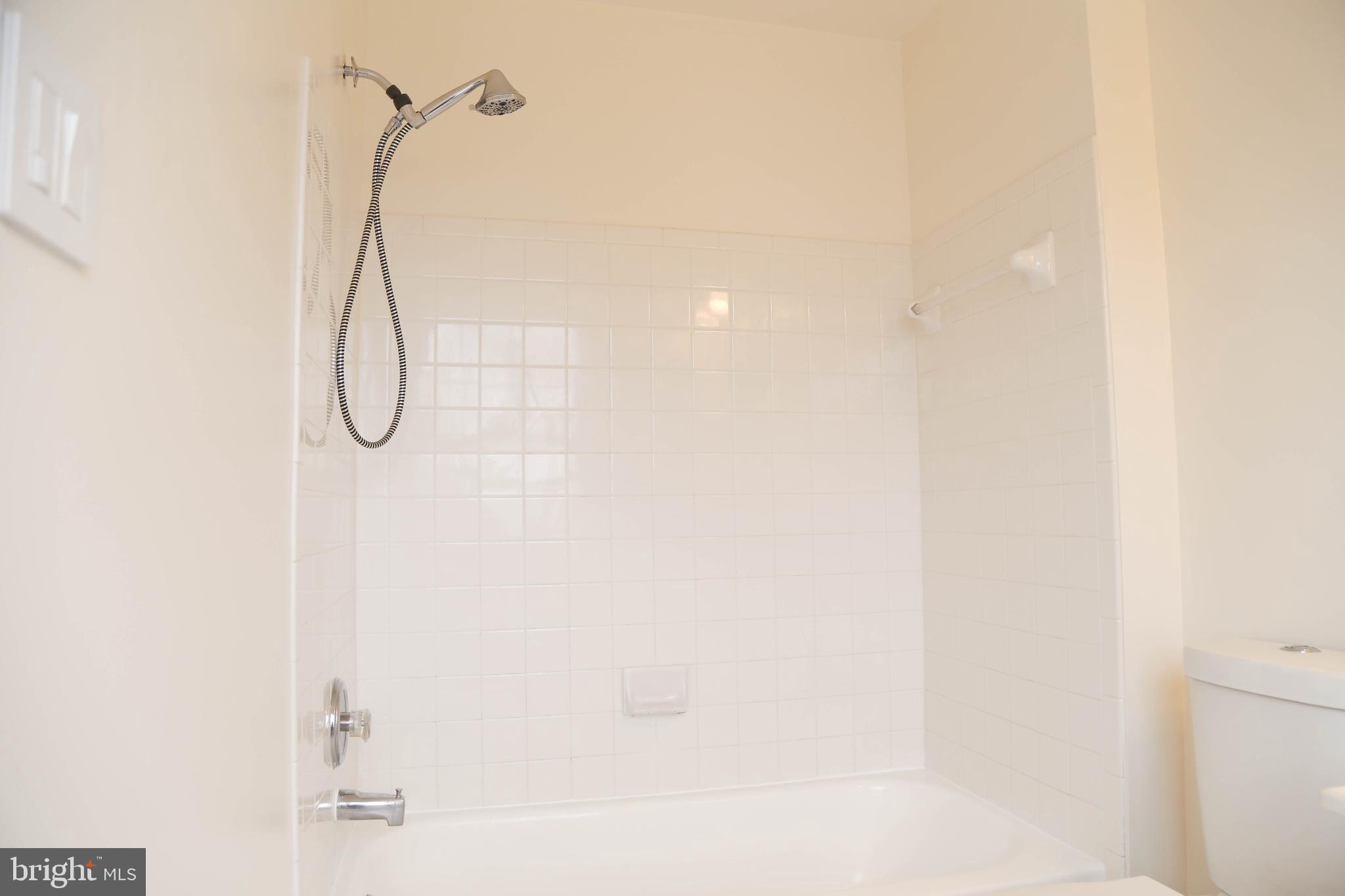 8461 Tackhouse Loop Gainesville, VA 20155 - Photo 17 of 39 a bathroom with a shower