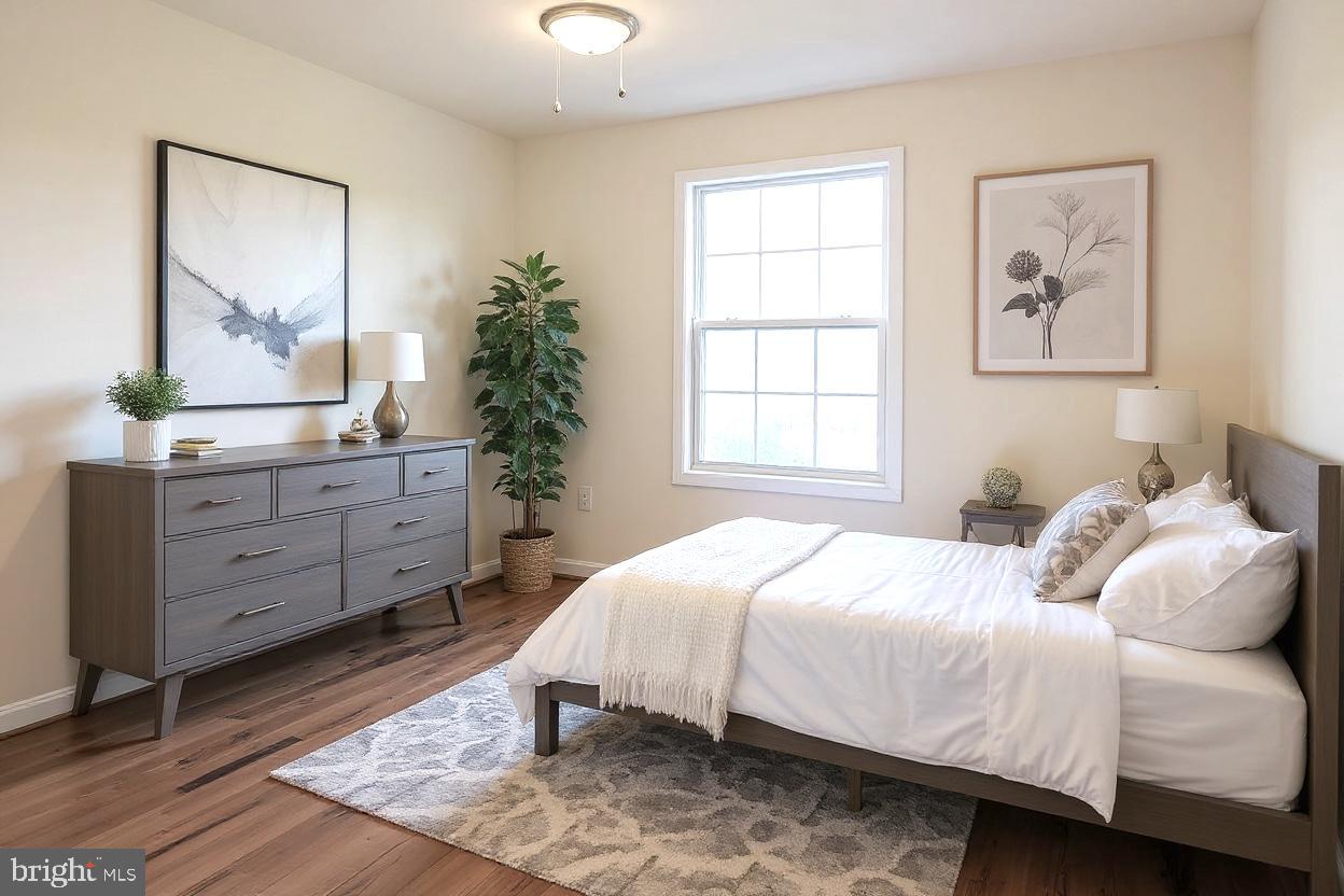 8461 Tackhouse Loop Gainesville, VA 20155 - Photo 19 of 39 a bedroom with a bed and a mirror on dresser